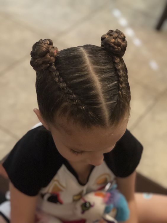 Girl with a cute braided pig tail buns
