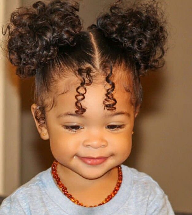 cute little girl with double curly puffs and two hair strands in the front