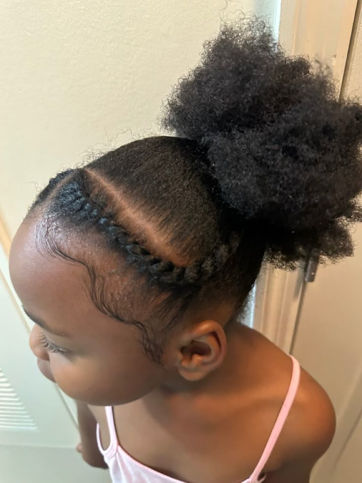 cute black girl with a low bun and with braids in the front.