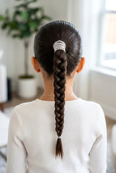 Braided ponytail wrapped at the base for a clean holiday-ready finish