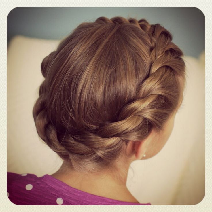 Girl wearing a twisted crown hairstyle with two twisted sections pinned at the back