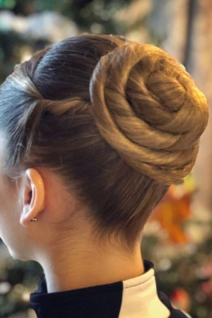 Child with a smooth, wrapped cinnamon roll bun for a polished school look