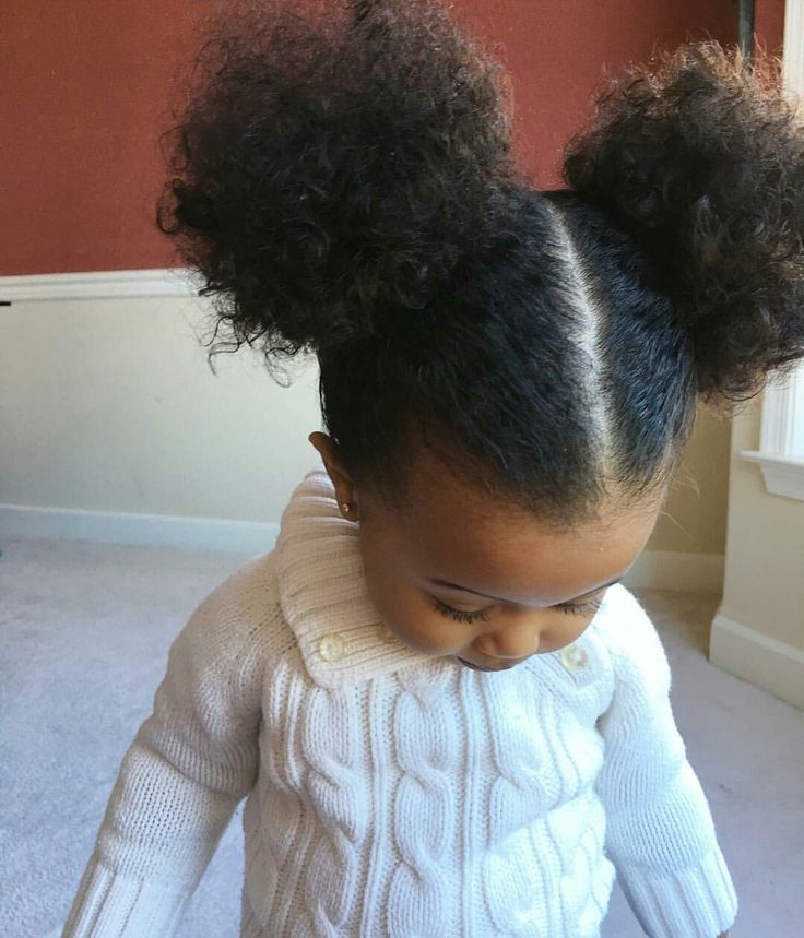 Child wearing two rounded double puffs on natural hair for a playful school look