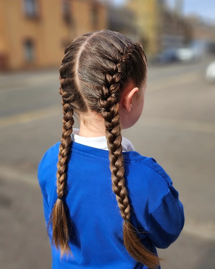 Young girl with a french braid pigtail hairstlye standing outdoors