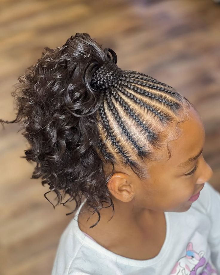 Little girl with cornrows gathered into a curly high ponytail