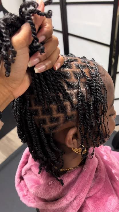 Child with a neat minitwist hairstyle