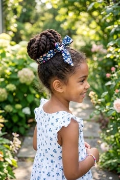 Young girl with a high puff styled with a fabric headband