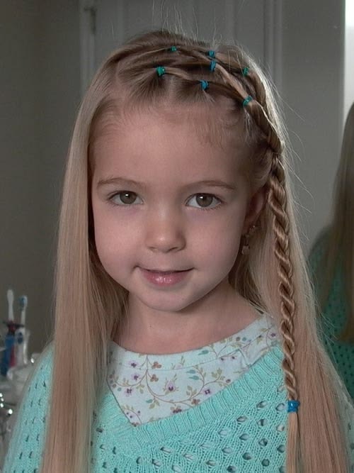 Young girl with side sweep  with baby braid.