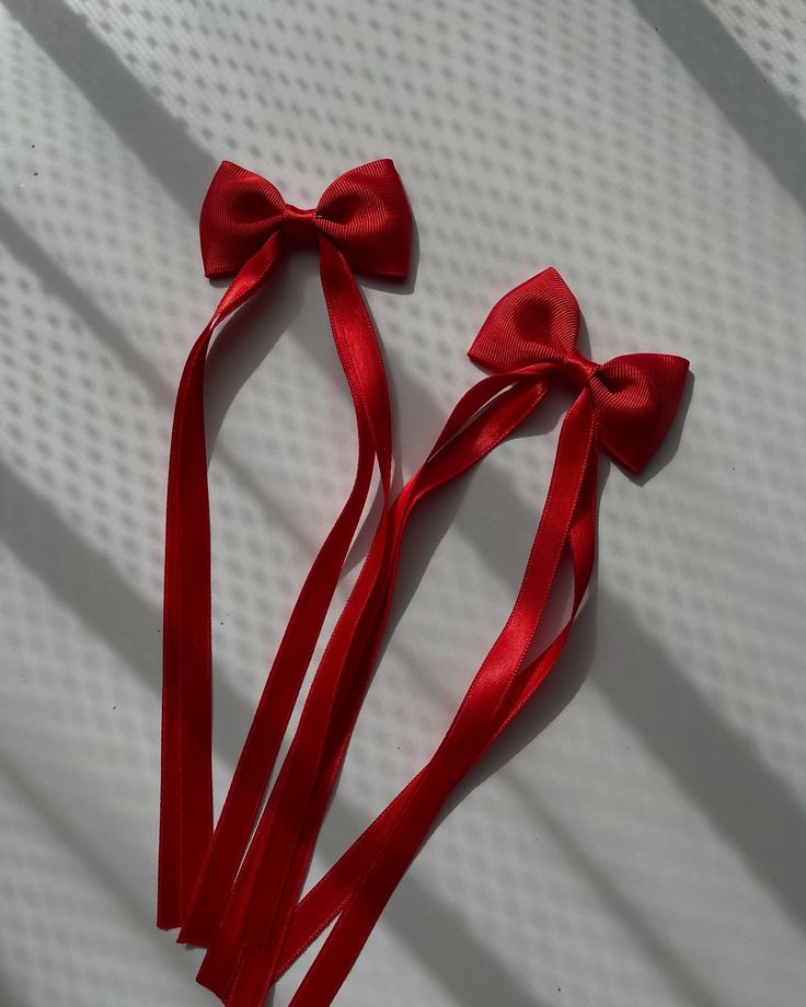Two pieces of red tie on ribbon bows for kids