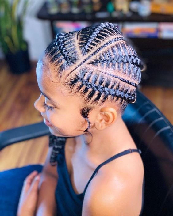 Feed in braids featuring alternating thick and thin braid sizes on a little girl.
