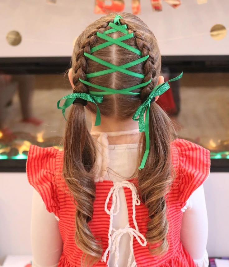 Young girl with a cute christmas tree braids wit a green ribbon 