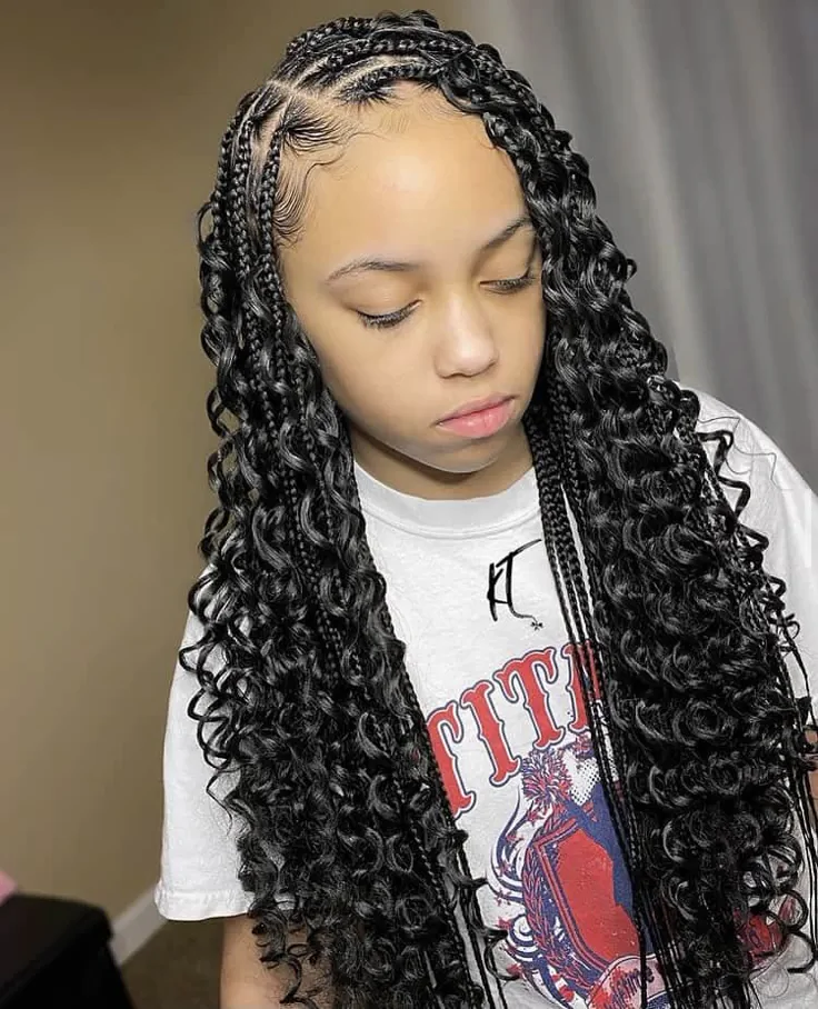 A child wears feed-in knotless braids with curly texture running through the full length, creating a boho look.