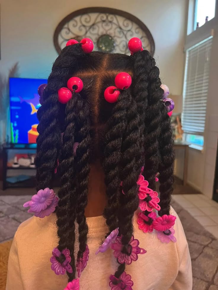 Young girl with braids finished with colorful barrettes