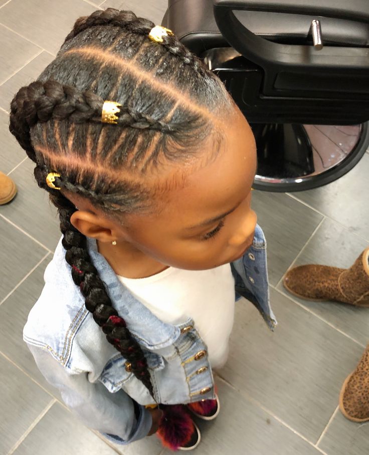 Little girl with four evenly spaced feed in braids.