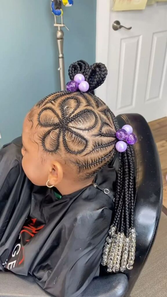 Little girl wearing feed in braids with a flower shaped parting.