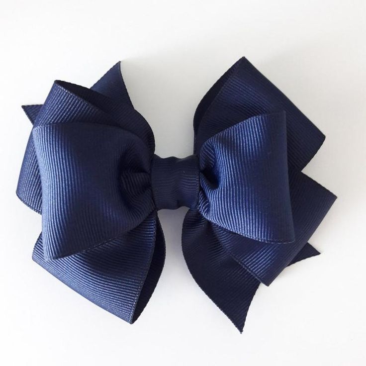 A navy blue layered grosgrain hair bow photographed on a white background.