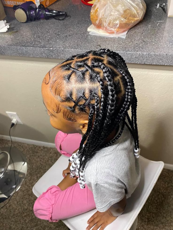 Crisscross knotless braids for kids featuring a creative front braid pattern.