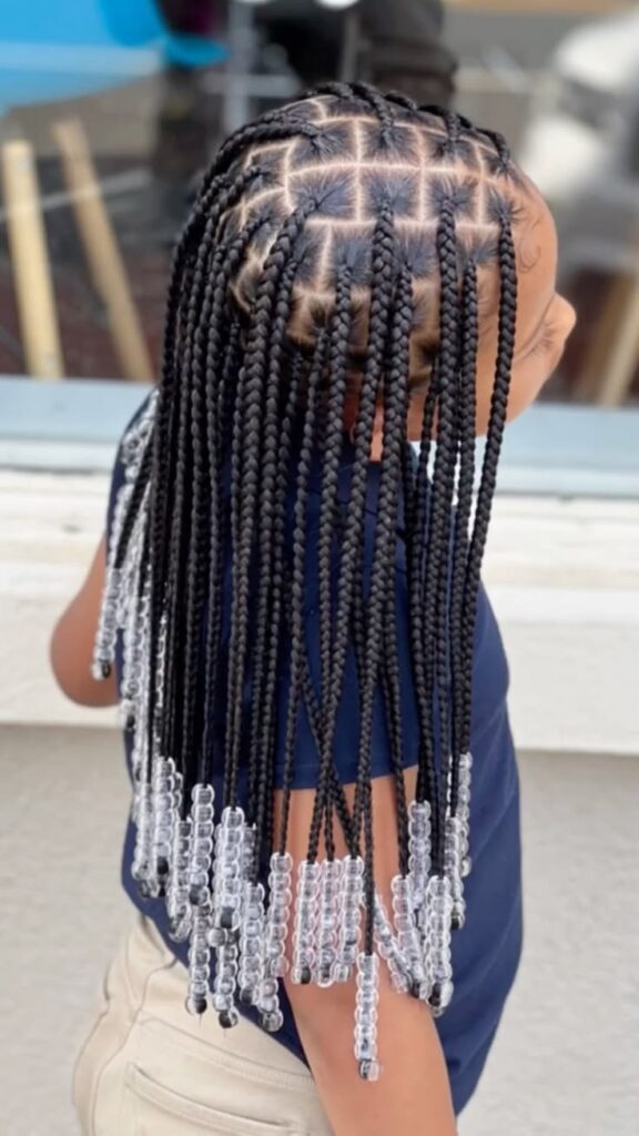 Child with neat braids finished with clear beads