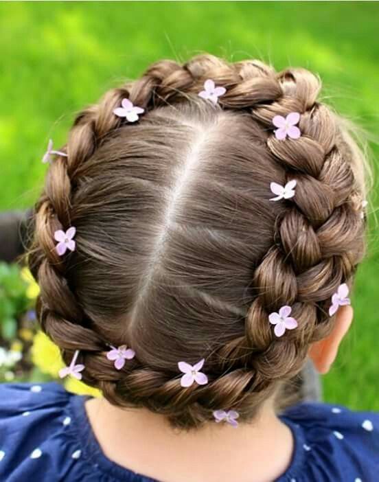 cute little girl with her hair in a halo braid with pink flower decorations