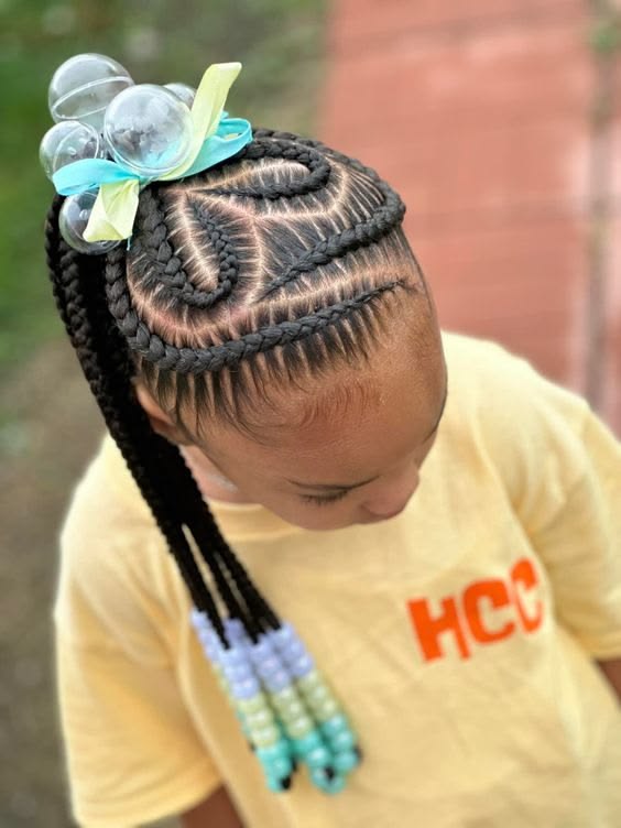 A YOUNG GIRL WITH  CUTE HEART BRAIDS HAIRSTYLE AND COLOURFUL BEADS