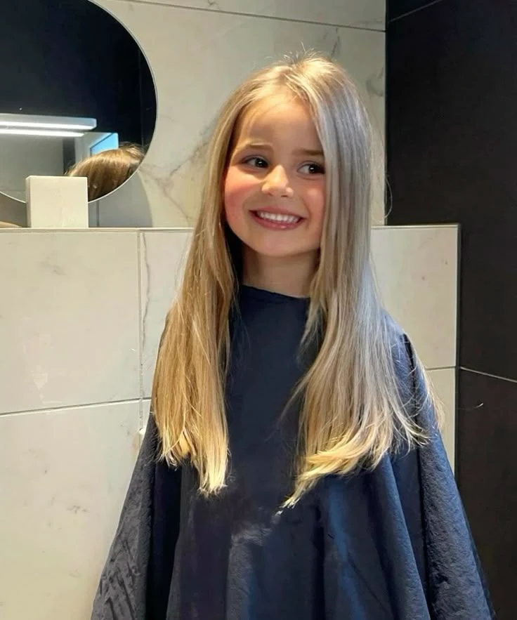 A young girl with a straight blond hair