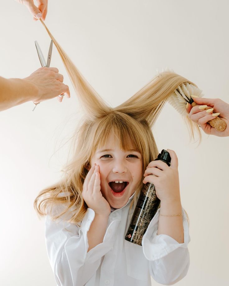 child getting hair trimmed and brushed