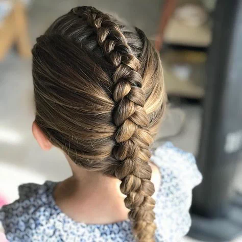 Young girl with straight hair styled in a single French braid