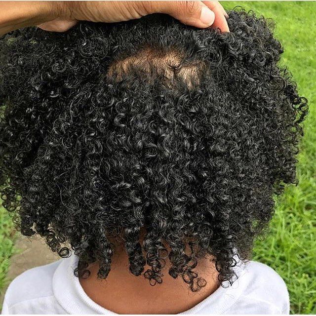 Healthy, full Type 4 curls parted to show scalp ,a natural hair care goal for kids