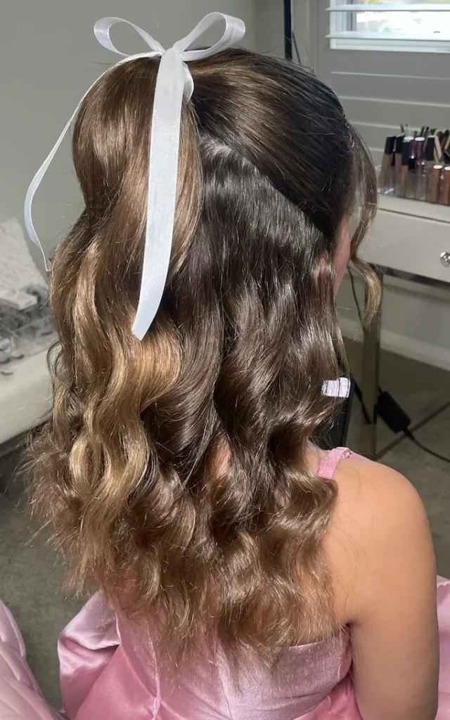 A young girl with one up ponytail