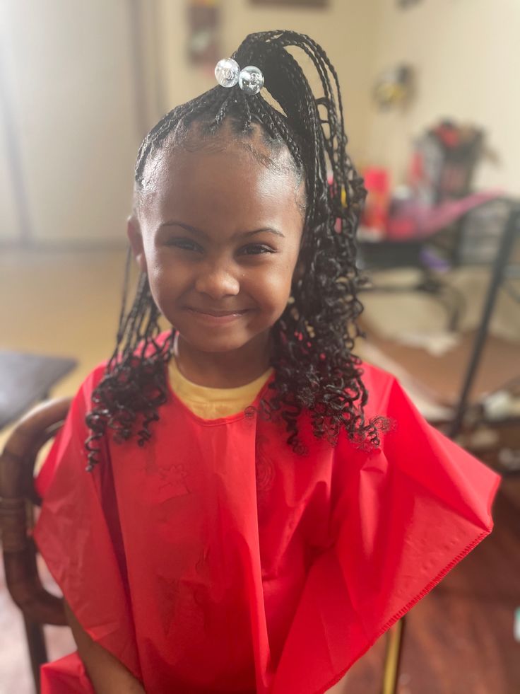 High ponytail knotless braids for kids with neatly gathered up with half flowing down 