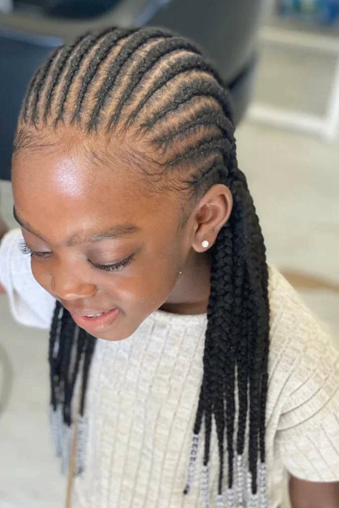 A child wears neat cornrows finished with silver beaded ends.