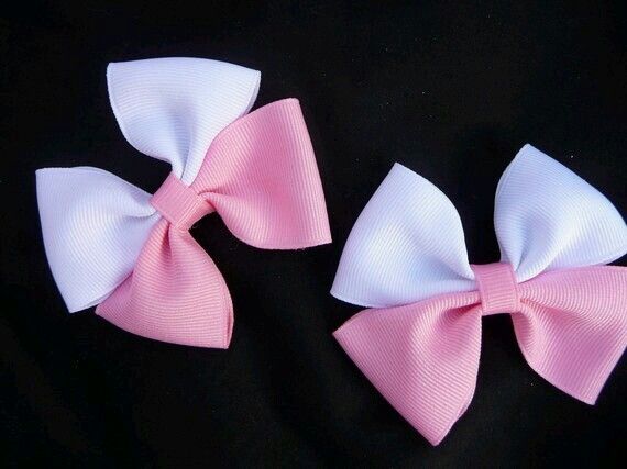 Cute white and pink double layered bow on a black background