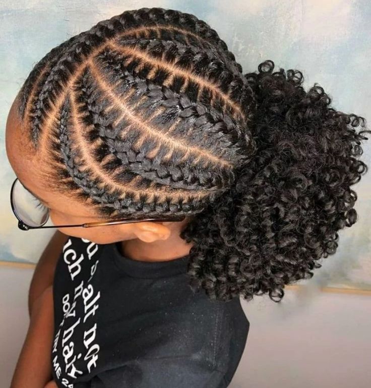 young girl with feed i braids and a curly puff at the back
