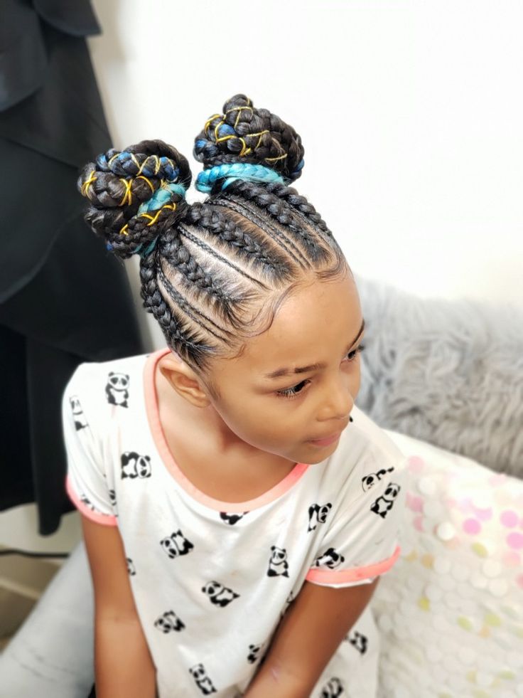 Feed in braids styled into two playful space buns for little girls.