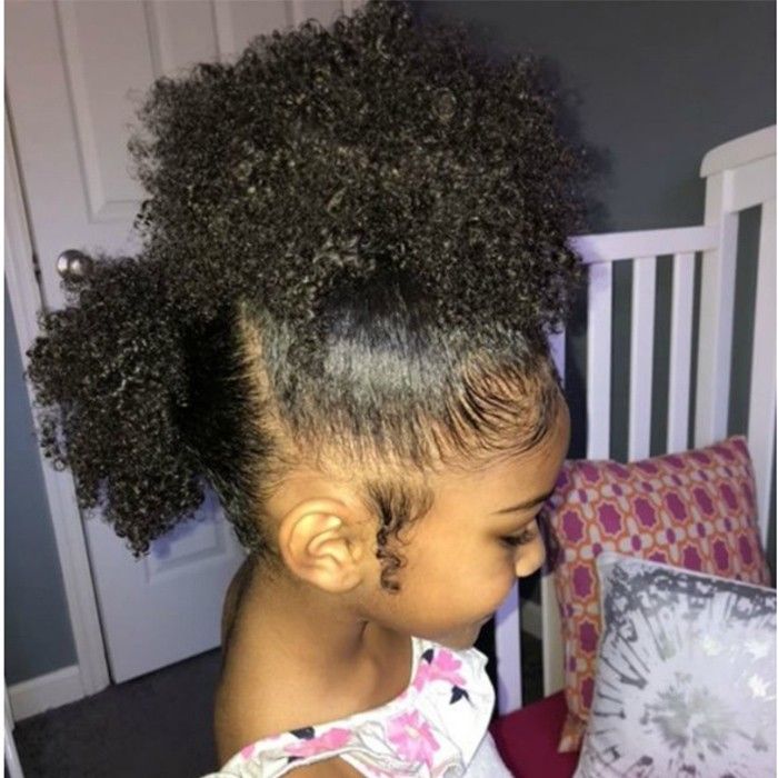 oung girl with curly hair styled in a half-up, half down puffs