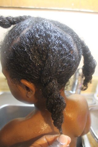 Child with freshly washed, damp curly hair after a gentle wash day