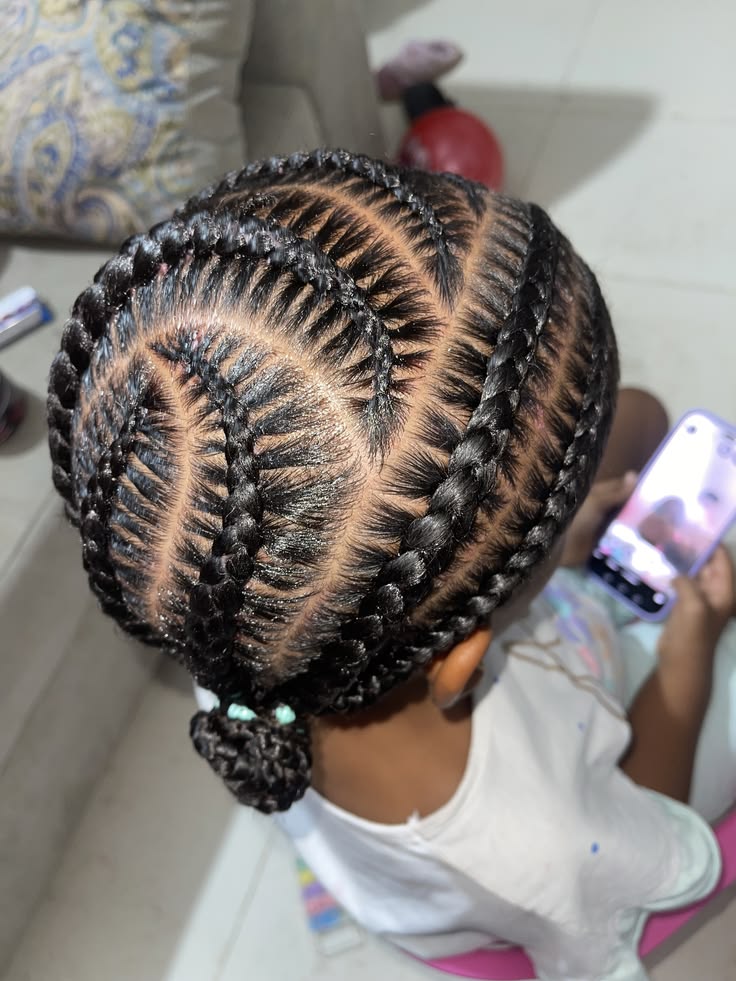 Young girl with a low bun cornrow 