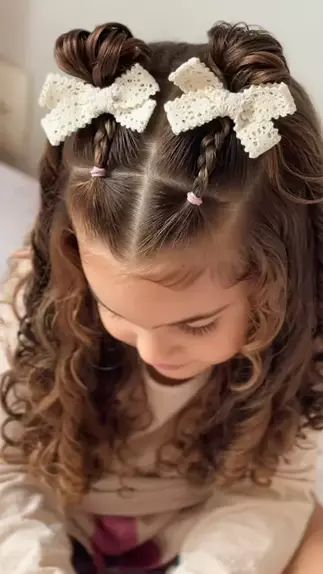 Young girl with straight hair styled in a half-up double  ponytail with a bows