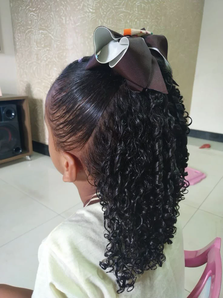 Cute black girl with half up ponytail with curls