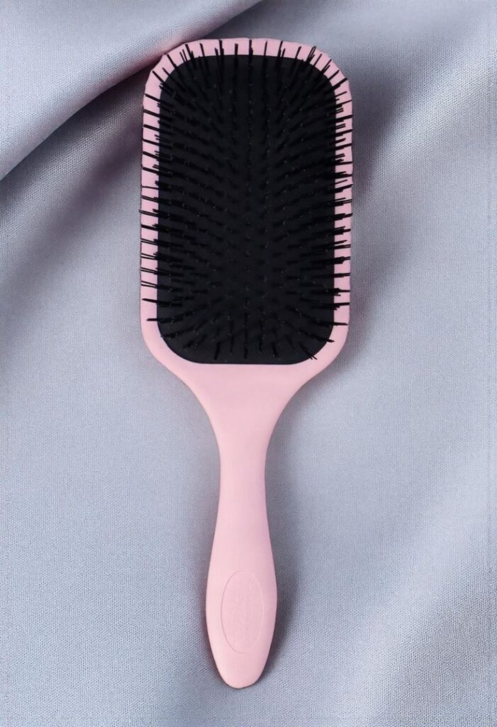 A pink and black detangling brush
