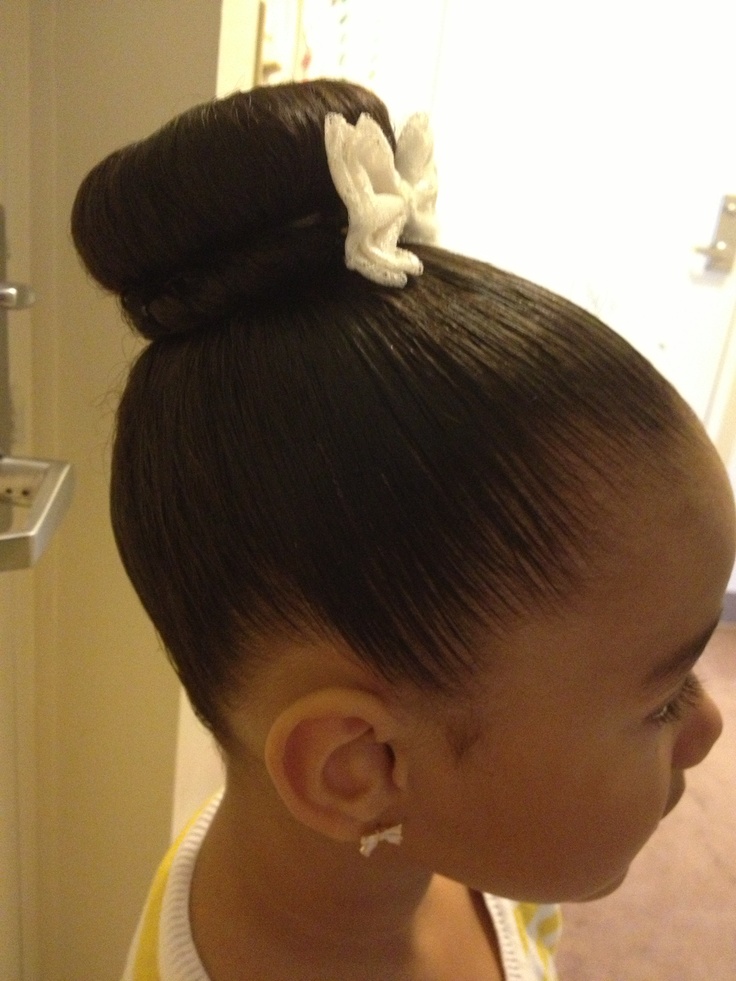 Young girl with hair styled in a high classic bun