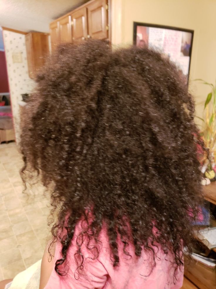 Dry, frizzy coily hair lacking definition, a common sign of overwashing and stripped natural moisture.