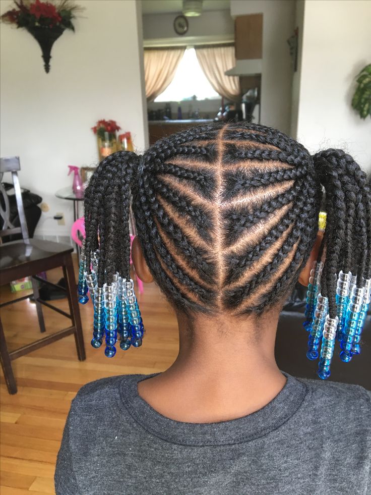Young girl with a cornrow into ponytails with colorful beads