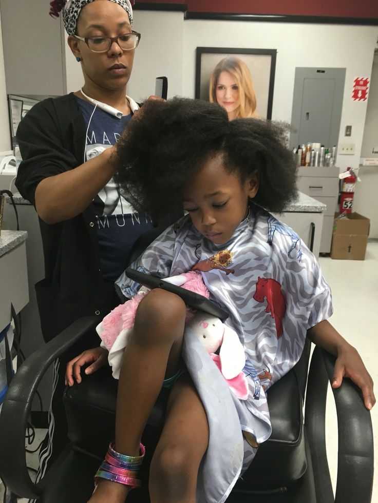 Professional stylist caring for type 4 hair
