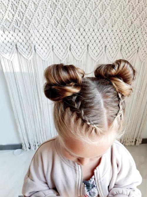 cute little toddler with a cute space bun with braids