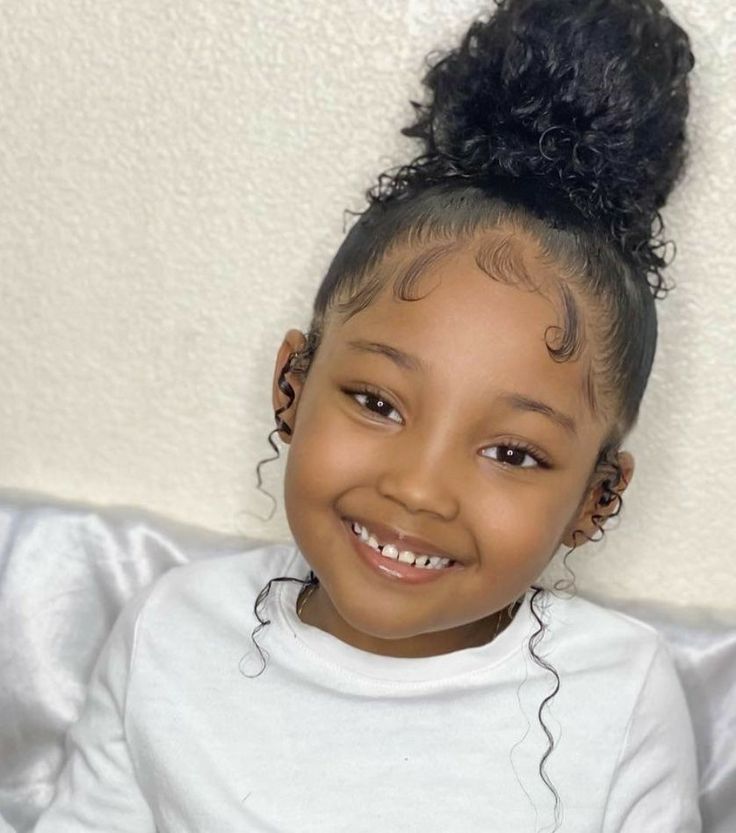 adorable girl with high puffs and pretty curly edges