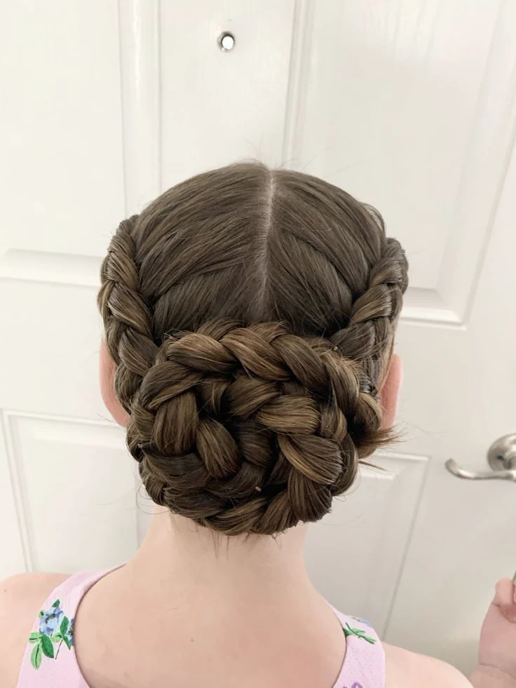 A young girl with a low twisted bun
