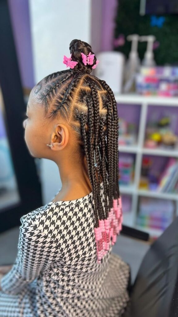 Half-up half-down knotless braids for kids with loose braids flowing down.