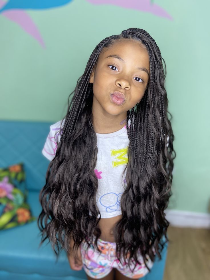 French curl knotless braids for kids with soft curly ends and neat braids.