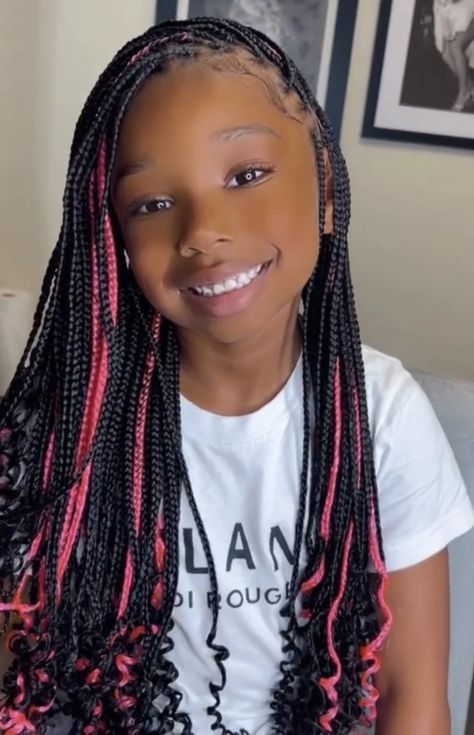 Peekaboo knotless braids for kids with hidden colored braids underneath.
